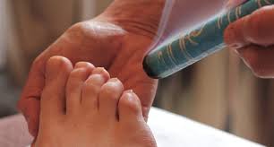 Moxibustion stick being held near foot